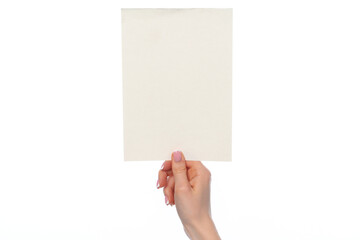 Female hand holding blank white sheet of paper isolated on white