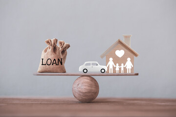 Loan bags with family member and car in a house on balance scale. Concept family financial...