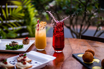 Cocktails splashing with ice with food