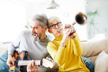 senior couple man woman love retired healthy party playing instrument guitar trumpet fun band iplay