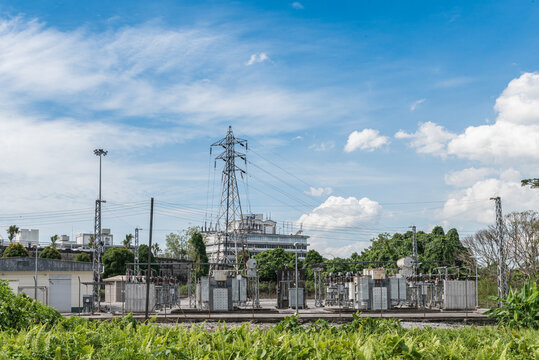 Kuching, Sarawak / Malaysia - June 21, 2016: Power substaion surrounded by bush in daylight.
