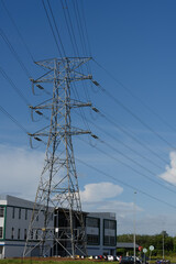 Kuching, Sarawak / Malaysia - August 28, 2017: Power pole and cables next to a building in blue sky.