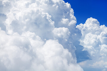 White cumulus clouds on clear blue sky background close up, beautiful aerial cloudscape view, azure...