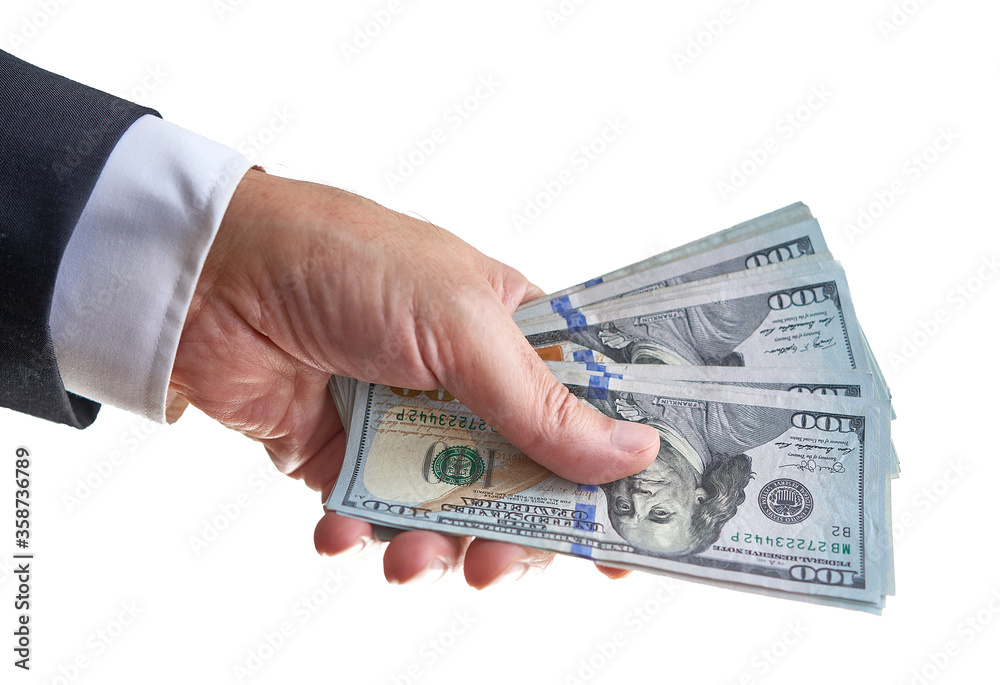 Wall mural Man hand holding a handful of dollar bills or money isolated on white background. Shallow depth of field.