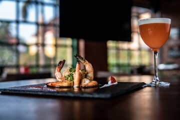 Amazing Prawns dish with orange cocktail
