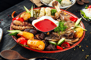 Assorted meat and potatoes on a traditional plate