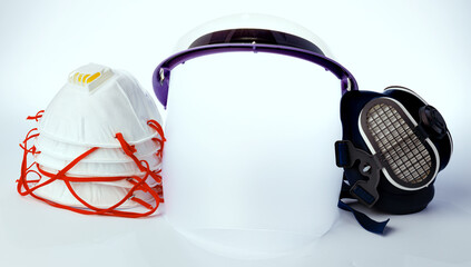 Medical face shield and protective masks on white background