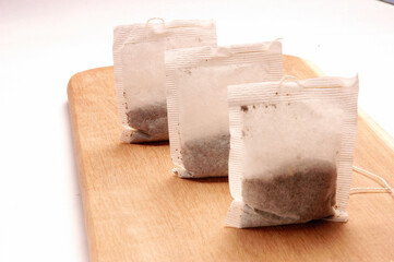 Tea Bags on wooden shingle in a row