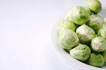 Brussel Sprouts on Plate on white background .