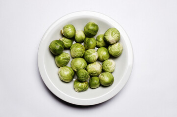 Brussel Sprouts on Plate on white background .