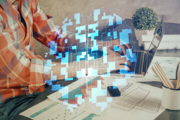 Multi exposure of technology hologram with man working on computer background. Concept of big data.