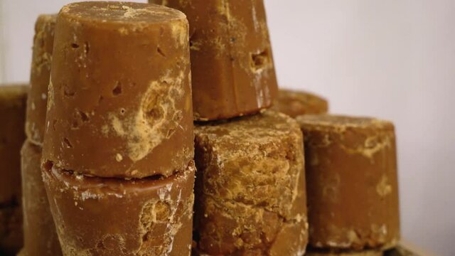 Pure organic jaggery blocks stacked up against white background