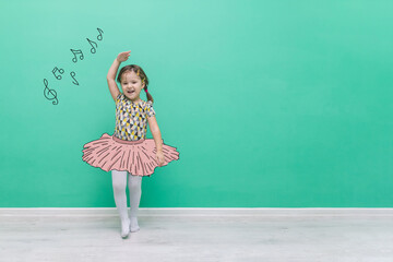 The child is dancing in a hand-drawn ballet tutu. Funny little girl on a turquoise background with...