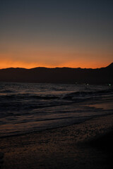Fototapeta na wymiar la-palms-beach-sunset-cloudy-waves-pier