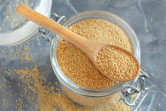 Glass jar of raw Amaranth Grain with a spoon