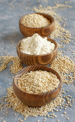 Bowls of raw white quinoa seeds and flour  close up