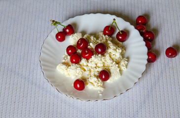 cottage cheese with red berries of a cherry