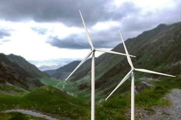 Alternative energy source. Wind turbines and mountains outdoors
