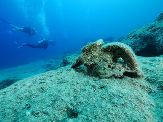 Fototapeta na wymiar scuba diver underwater exploring ancient amphoras deep water history search ocean scenery