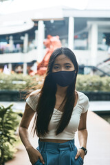 Woman wearing a mask for protecting disease and social distancing during travel in the public.