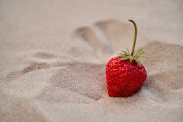 strawberry lie on the hot sand in the desert. Sand dunes © XELAR