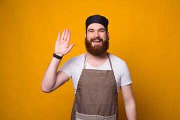 Photo of happy bearded Chef saluting everyone