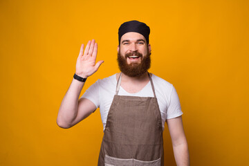 Fototapeta premium Photo of happy bearded Chef saluting everyone