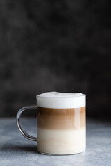 Cafe latte macchiato layered coffee in a a glass mug