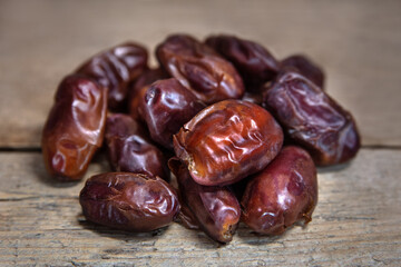 Dried dates on wooden table, sort khidri, sweet vegan superfruit