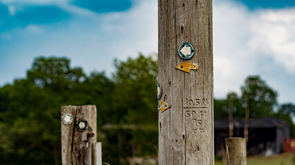 Walking path directional markers on a telegraph pole for UK countryside right of way paths