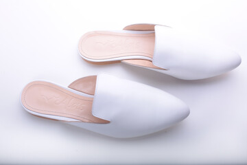 beautiful women's shoes on legs and layouts, leather white mules and loafers, in the interior of a room or office, a girl shoes, blue skirt and white shoes, a noble and elegant style, modern and trend