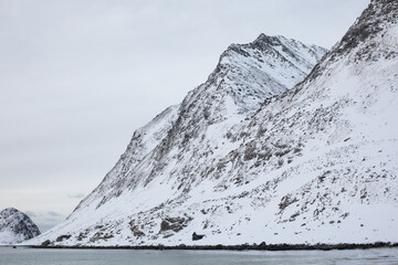 A snowy mountain on Haukland beach in the Lofoten Islands. 
