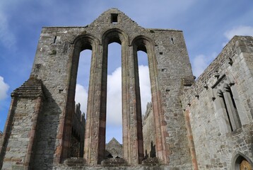 The dramatic, tall, arched and empty windows in a ruined church.