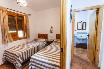 Bedroom and bathroom inside an old-style rural rental house.