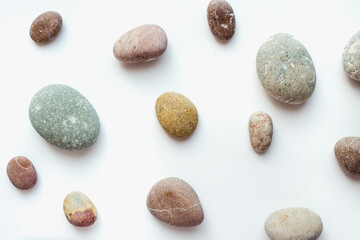 sea stones on white background, smooth stones