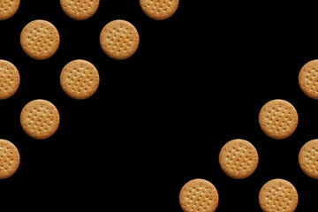 pattern with multiplied circling cookies on a black background. Place for text