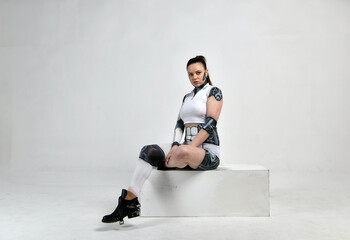 beautiful brunette girl in a robot suit posing on a white background
