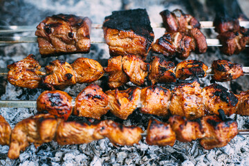 Chicken skewers on skewers on fire. Cooking meat outdoors in the open air..