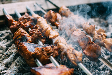 Skewers of pork ribs and chicken on skewers. Grilled meat. Cooking outdoors..