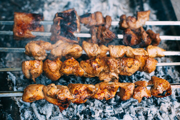 Chicken skewers on skewers on fire. Cooking meat outdoors in the open air..