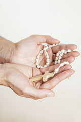 Hands with Rosary on white background
