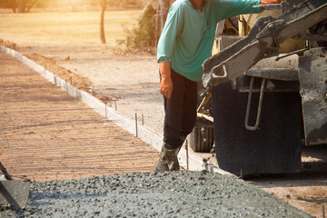 Workers pouring concrete with a cement mixer truck