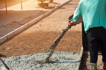 Workers pouring concrete with a cement mixer truck