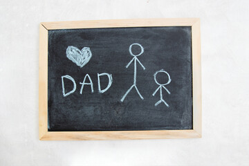 Dad and a heart for Happy Father's Day inscription at blackboard