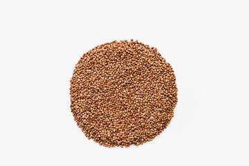 buckwheat groats on a white background, a bunch of buckwheat