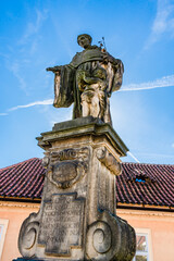 Fototapeta na wymiar Outdoor statue of Saint Nicholas of Tolentino on the south side of Charles Bridge over the river Vltava in Prague, Czech Republic