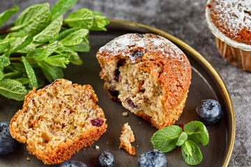 Freshly baked blueberry muffins. Cupcakes sprinkled with powdered Sugar.