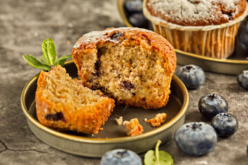 Freshly baked blueberry muffins. Cupcakes sprinkled with powdered Sugar.