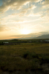 
Sunset in the village over meadows and mountains