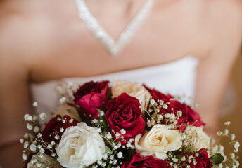 bride holding bouquet, bridal bouquet of red roses